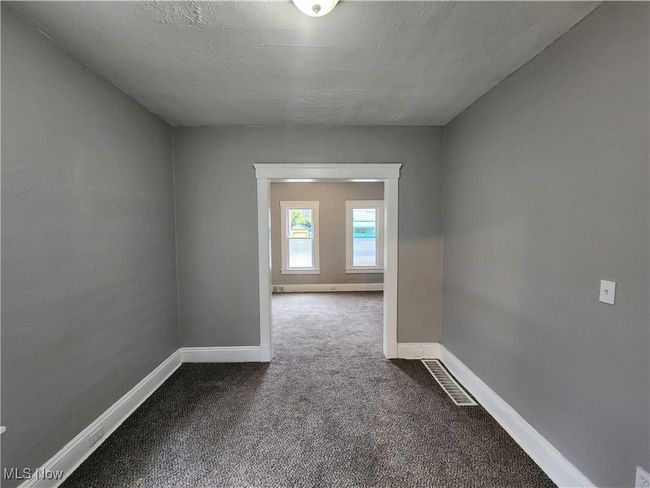 Empty room featuring carpet and a textured ceiling | Image 8