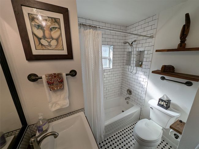 Bathroom featuring mid-century style with checkered patterned tile | Image 12