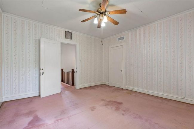 Spare room with carpet floors, a ceiling fan, and visible vents. | Image 16
