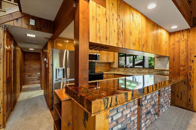 Dining bar with custom made epoxy manzanita bar top. | Image 31