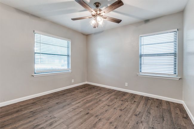 Empty room featuring a ceiling fan and dark wood-type flooring | Image 16