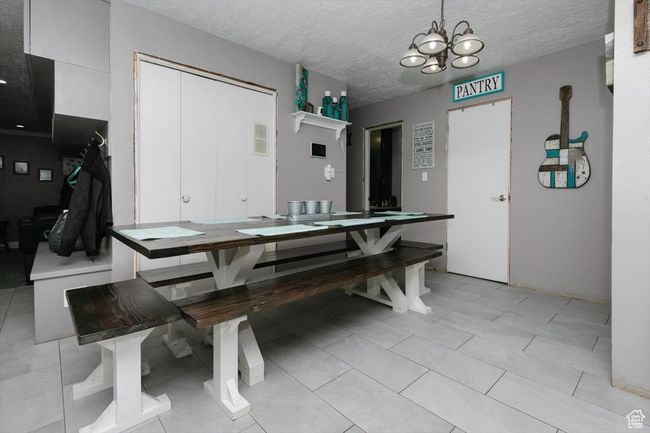 Dining area with visible vents, a chandelier, and a textured ceiling | Image 8