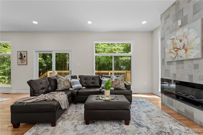 Living area featuring a tile fireplace, recessed lighting, and wood finished floors | Image 17