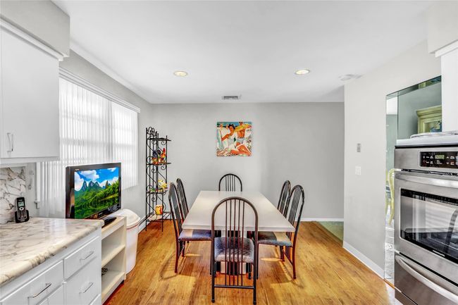 Dining room with light wood-type flooring | Image 17