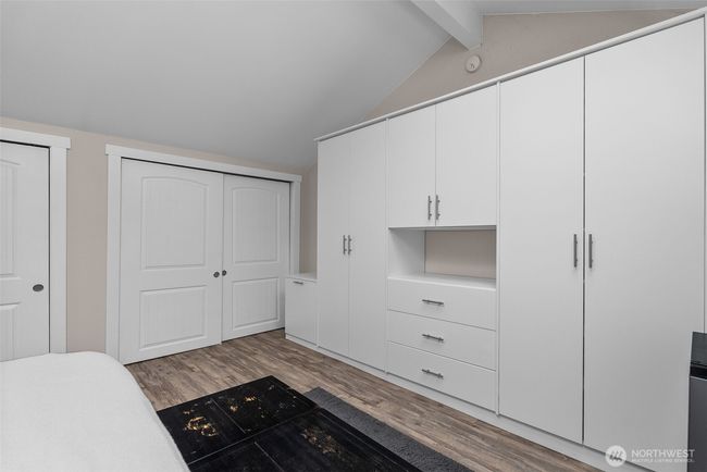Primary bedroom - tons of closet space, wardrobe, and inside the walk-in closet is a doorway to added storage space | Image 20