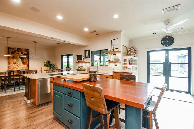 Picture having dinner parties in this home with the space to move and prep food while mingling with your guests! Notice the second set of French Doors leading to the outdoor kitchen. | Image 15