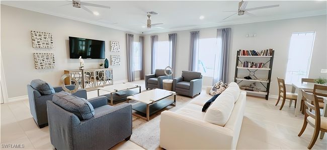 Living area featuring a ceiling fan, healthy amount of natural light, crown molding, baseboards, and recessed lighting | Image 25