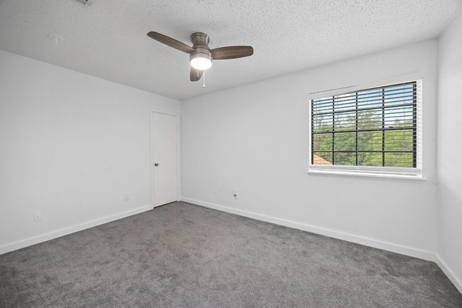 Empty room featuring baseboards, a ceiling fan, carpet flooring, and a textured ceiling | Image 22