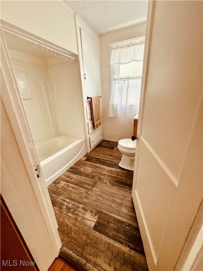 Bathroom with newer lvp floors, newer tub/shower and fresh paint. | Image 10