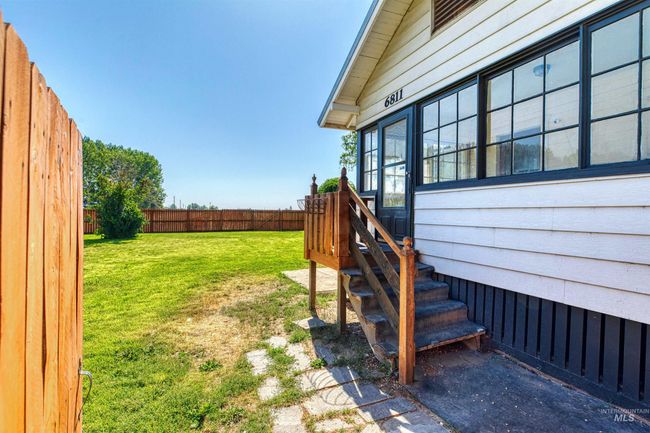 View of fenced backyard | Image 34