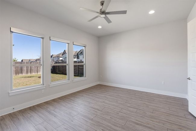 Unfurnished room featuring light wood finished floors, a ceiling fan, and recessed lighting | Image 17