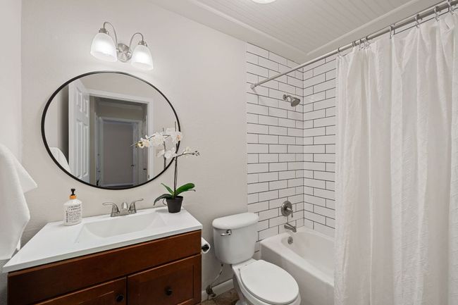 Hallway bathroom is located next to the two secondary bedrooms and has an updated vanity, mirror, backsplash and light package. | Image 24