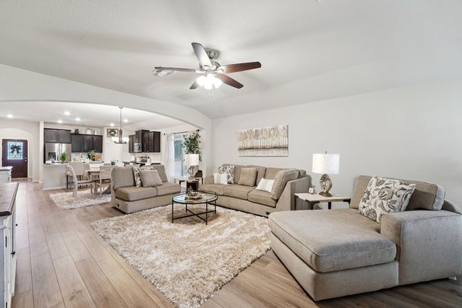 Living room featuring arched walkways, a ceiling fan, recessed lighting, and wood finished floors | Image 7