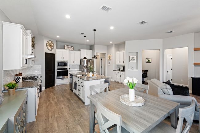 Dining area with light wood-type flooring, visible vents, and recessed lighting | Image 15