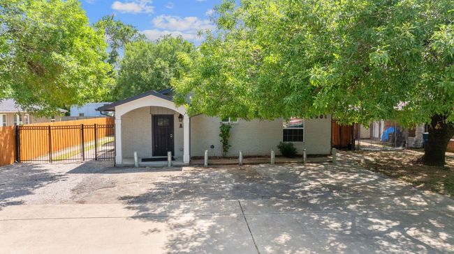 View of front facade featuring brick siding, a fenced front yard, and a gate | Image 37