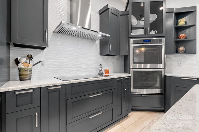 Primary Kitchen Induction Cooktop with Range Hood and double ovens. | Image 12