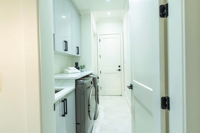Washroom featuring cabinet space, separate washer and dryer, recessed lighting, and ornamental molding | Image 17