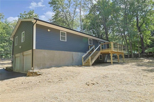 Rear view of house with a garage and a wooden deck | Image 26
