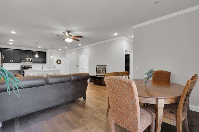 Dining space with recessed lighting, ceiling fan, light wood finished floors, crown molding, and baseboards | Image 10