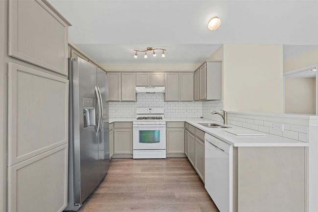 Light countertops offer a fresh, inviting space for cooking | Image 6