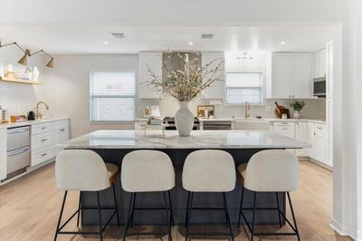 Chef's kitchen fully remodeled in 2021 with stainless appliances, Oversized island with quartzite/marble counters, recessed lighting and more! | Image 1