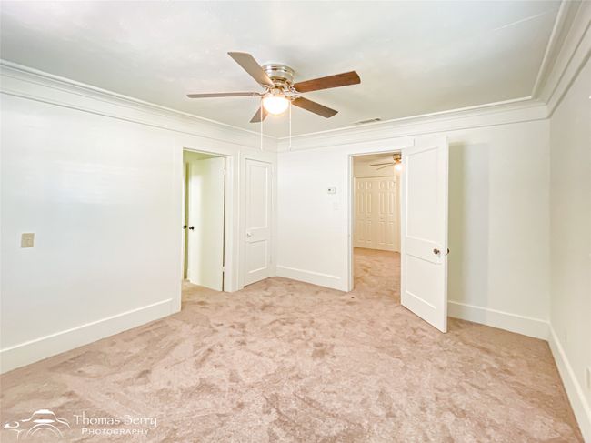Unfurnished room with ceiling fan, crown molding, and carpet flooring | Image 19