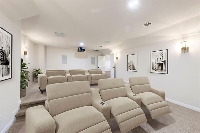 The upgraded media room offers built-in surround sound, and a mounted projector for a true home theater experience—designed for immersive movie nights and unforgettable gatherings. *This photo has been virtually staged.* | Image 37