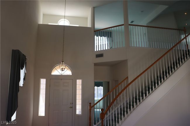 Entryway featuring a towering ceiling, stairway, and plenty of natural light | Image 18