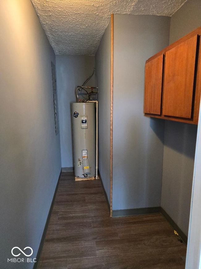 utility room featuring electric water heater | Image 29