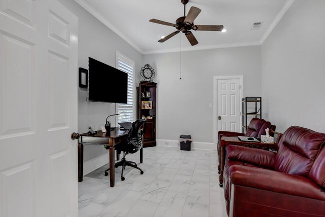 Office area with a ceiling fan, crown molding, light marble finish flooring, and recessed lighting | Image 31