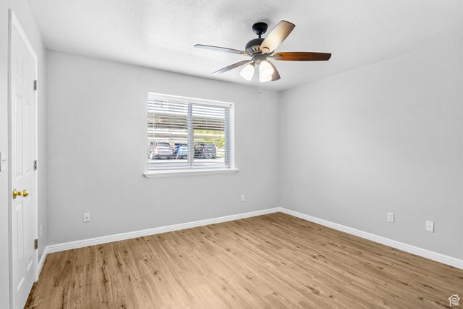 Spare room with light wood-style floors, baseboards, and ceiling fan | Image 22