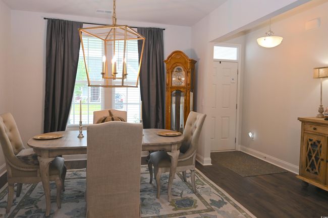 Dining area with wood finished floors and baseboards | Image 4