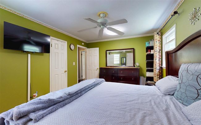 Bedroom featuring crown molding and ceiling fan | Image 28