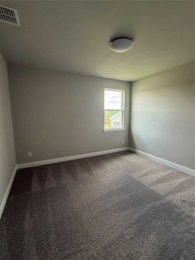 Carpeted empty room featuring baseboards | Image 21
