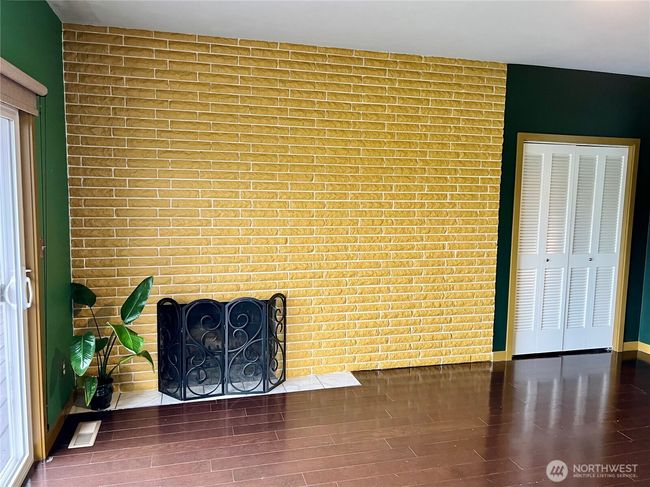 Cozy fireplace in primary suite. Showing one of two closets. | Image 10