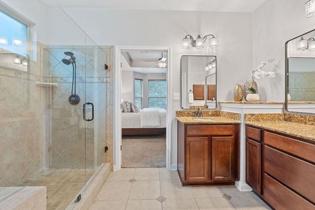 Ensuite bathroom with a walk-in shower and dual vanities. | Image 23