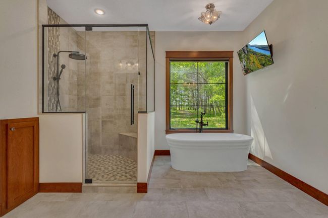 Luxurious custom tile shower paired with a serene soaker tub, creating a spa-like retreat in your bathroom. | Image 50