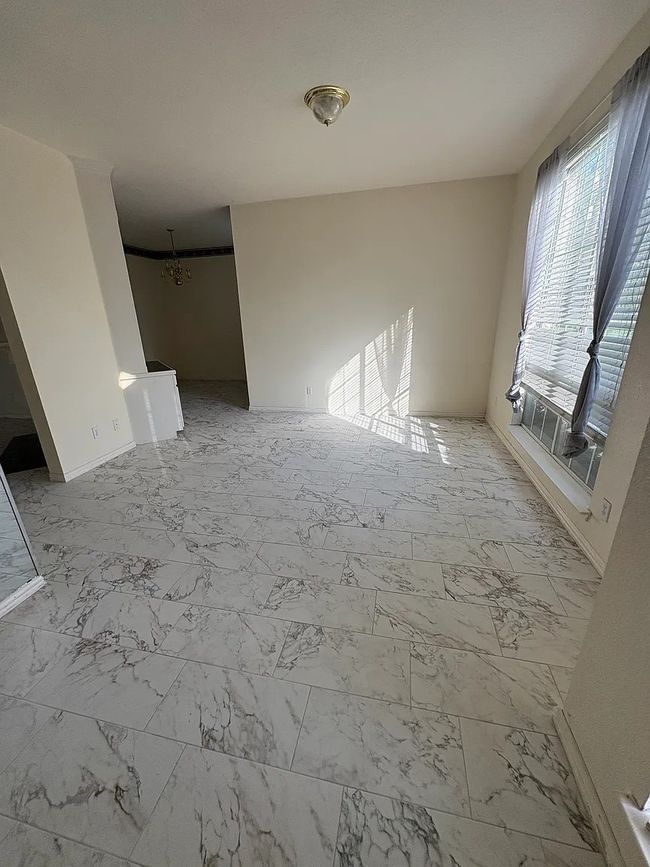 Unfurnished living room featuring light marble finish flooring | Image 10