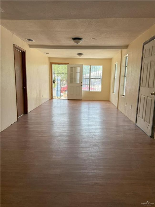 Unfurnished room featuring visible vents, a textured ceiling, and wood finished floors | Image 19