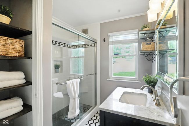 full bathroom featuring crown molding, tiled shower, and vanity | Image 26