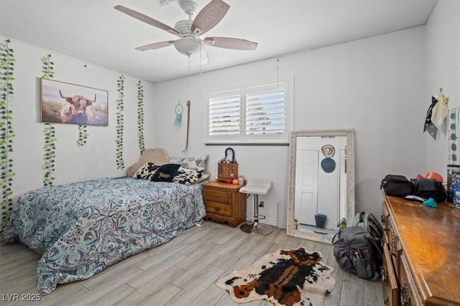Bedroom with wood finished floors and a ceiling fan | Image 17