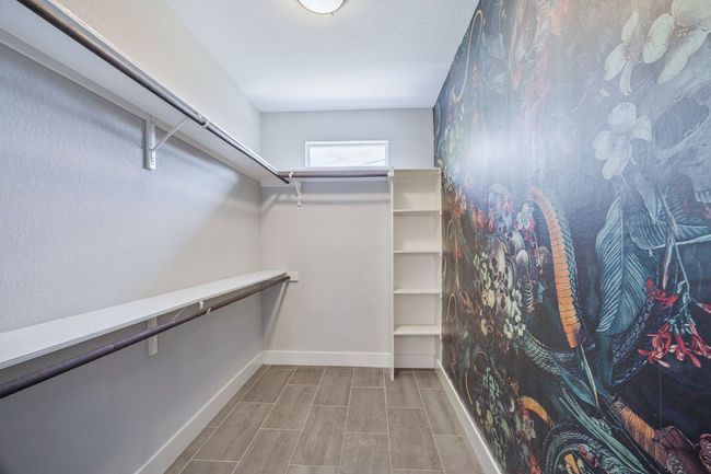 Spacious closet with wood finished floors | Image 25