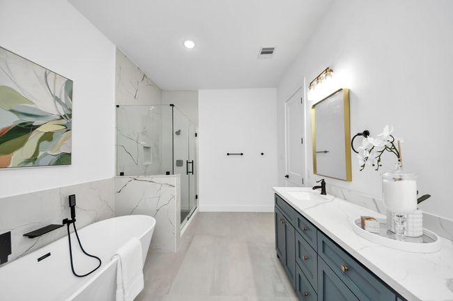 The walk-in shower has a glass door. | Image 19