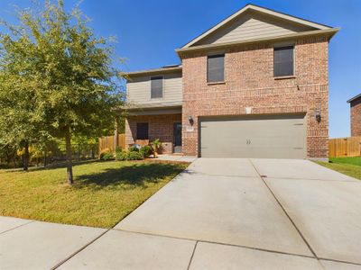 Front facade featuring a front yard and a garage | Image 1