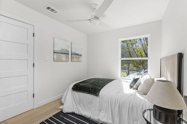 Bedroom with wood finished floors and a ceiling fan | Image 19