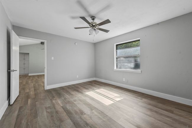 Unfurnished room with ceiling fan and dark hardwood / wood-style flooring | Image 22