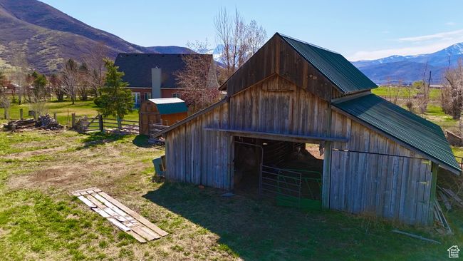 View of barn with a mountain view and fence | Image 31