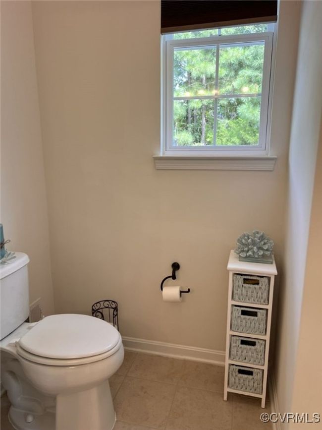 Bathroom with toilet and tile patterned floors | Image 36