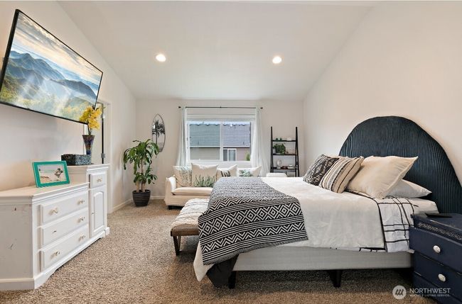 Spacious and serene primary suite featuring a private ensuite bath with dual sinks, a soaking tub, separate shower, and walk-in closet—your personal retreat at the end of the day. | Image 19