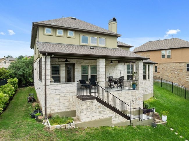 Back of property featuring a covered patio and privacy thanks to the green belt behind. | Image 25